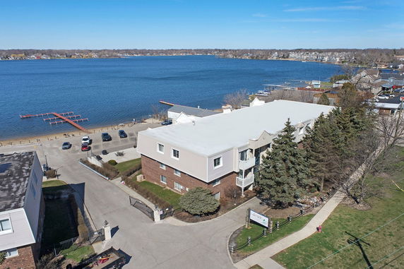 Panoramic view of a multi-story building near a large body of water.
