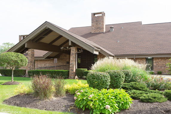 Front view of a building with a gabled roof and brick exterior.