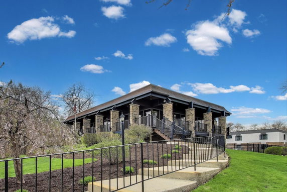Front view of a building with stone pillars and a raised platform.