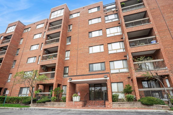 Front view of a multi-story brick apartment building.