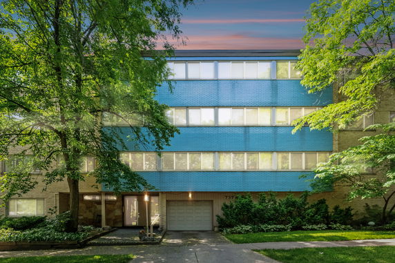 Front view of a multi-story building with blue and beige exterior.