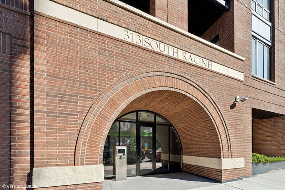 Front view of a brick building with an arched entrance.