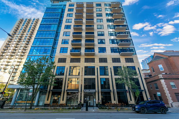Front view of a multi-story apartment building with balconies.