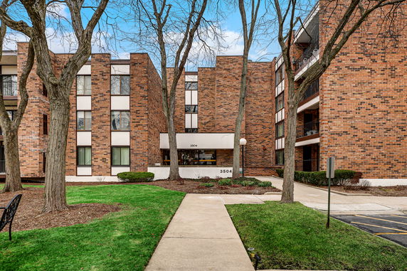 Front view of a brick multi-story apartment building entrance