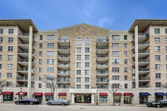 Front view of a multi-story apartment building with balconies.