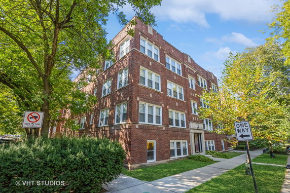 Front view of a multi-story brick apartment building.