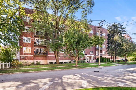 Front view of a multi-story brick apartment building.