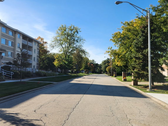Front view of a multi-story apartment building with balconies.