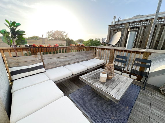 Rooftop with seating area, satellite dish, and decorative elements.