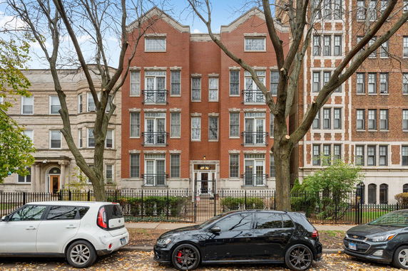 Front view of a multi-story brick apartment building.