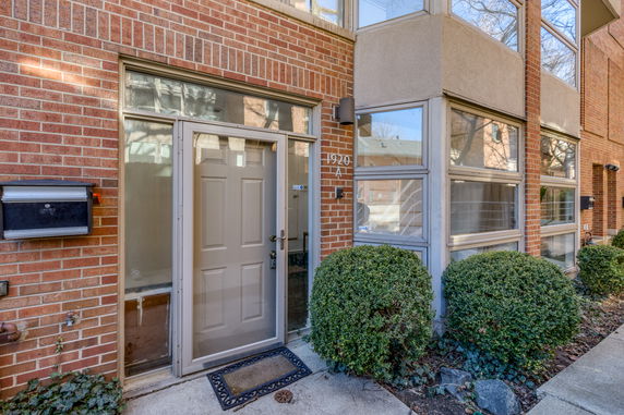 Front view of a house with brick exterior and multiple windows.
