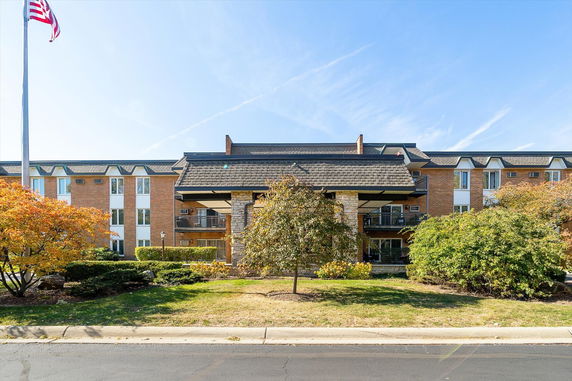 Front view of a multi-story building with brick exterior and a prominent entrance.