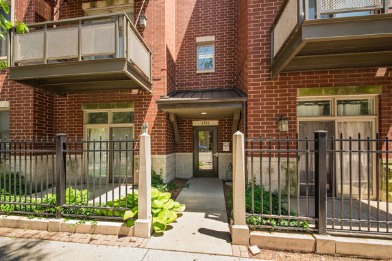 Front view of a building with brick exterior and balconies.