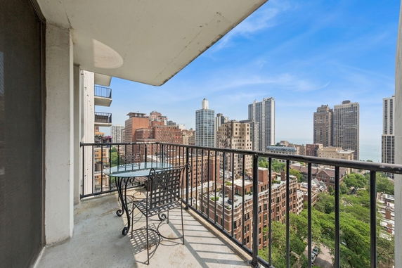 Balcony view overlooking cityscape with high-rise buildings.