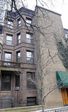 Front view of a multi-story building with brick exterior.