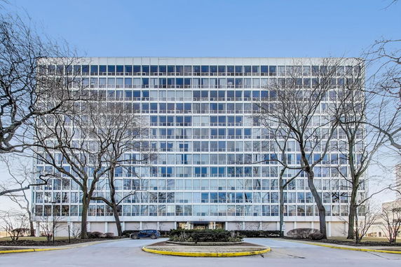 Front view of a multi-story building with a grid-like window facade.