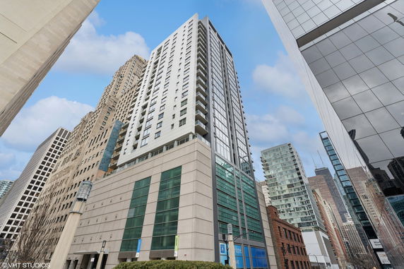 Front view of a high-rise building with modern architecture in an urban setting.