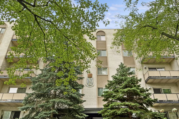 Front view of a multi-story apartment building with balconies.