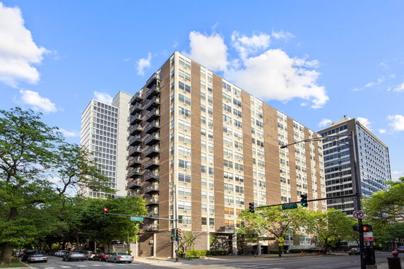 Front view of a multi-story apartment building with balconies.