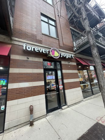 Front view of a building with a yogurt shop entrance.