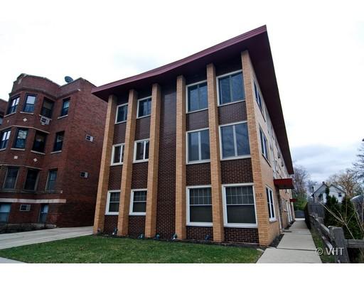 Front view of a multi-story building with a unique roof design.
