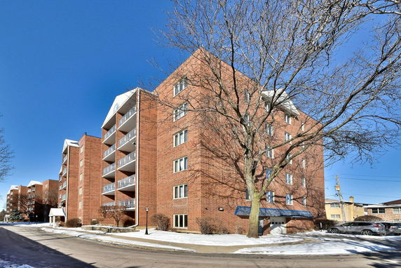 Front view of a multi-story brick apartment building
