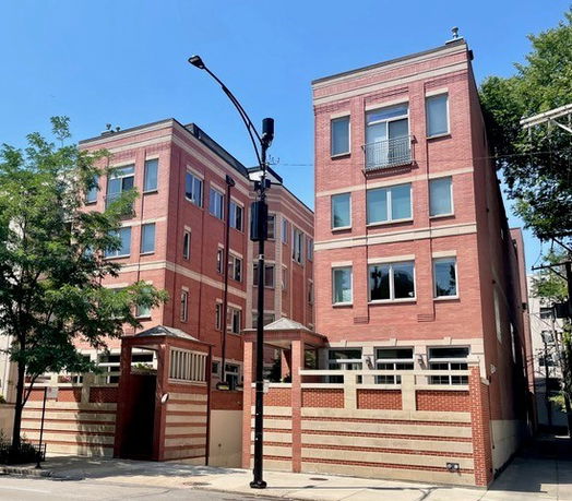 Front view of two adjacent multi-story brick buildings.