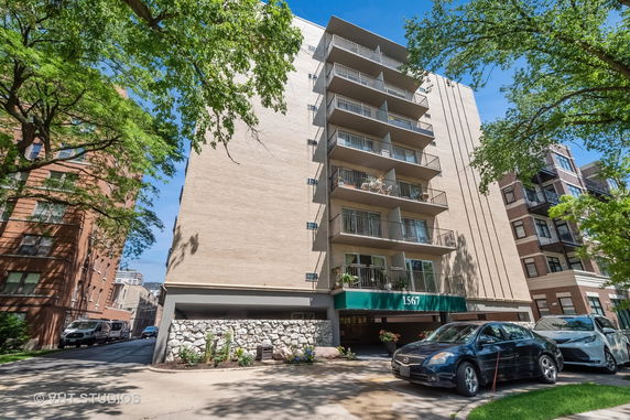 Front view of a multi-story residential building with balconies.