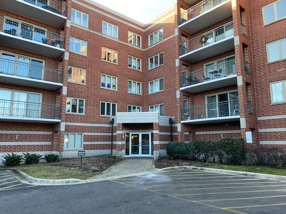 Front view of a multi-story brick apartment building.