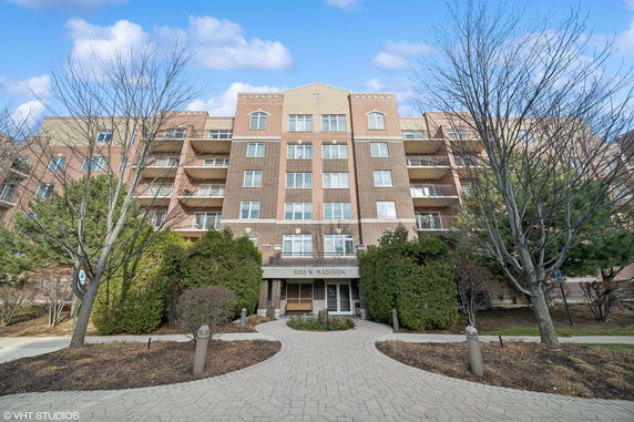 Front view of a multi-story brick building with balconies.