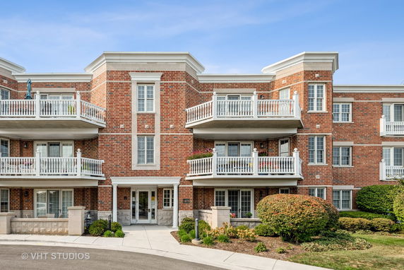 Front view of a multi-story brick building with balconies.