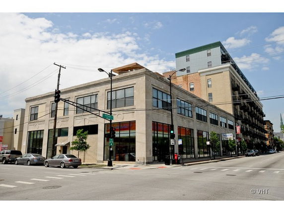 Front view of a two-story commercial building at a street corner.