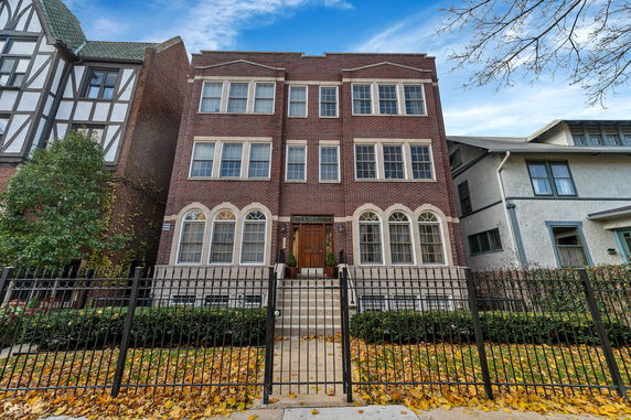 Front view of a three-story brick building with multiple windows and a central entrance.
