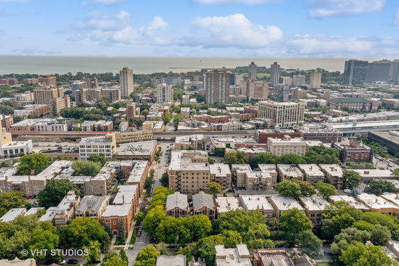Panoramic view of a cityscape with multiple buildings and greenery.