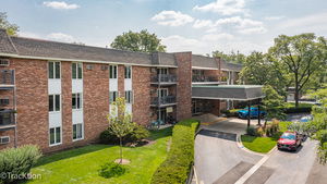 Front view of a multi-story brick building with a covered entrance.