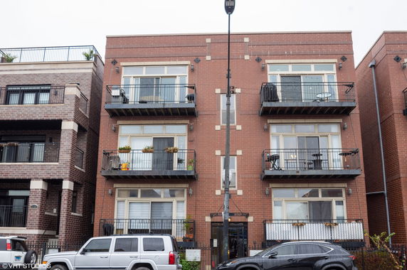 Front view of an apartment building with balconies.