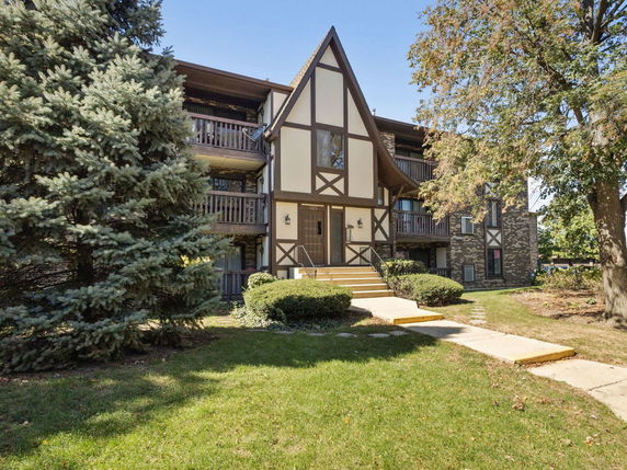 Front view of a multi-story building with Tudor-style architecture.