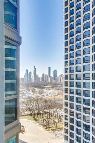 View from a building showing a city skyline in the background with other buildings and roads.