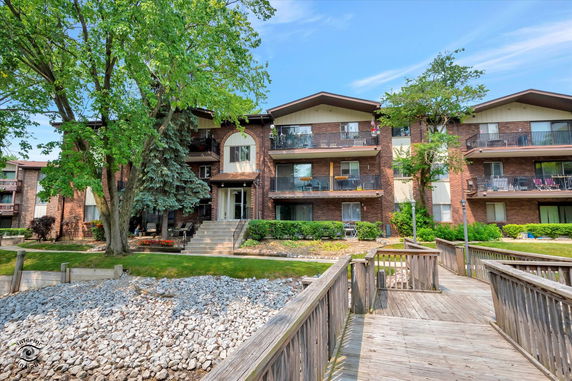 Front view of a multi-story residential building with balconies.