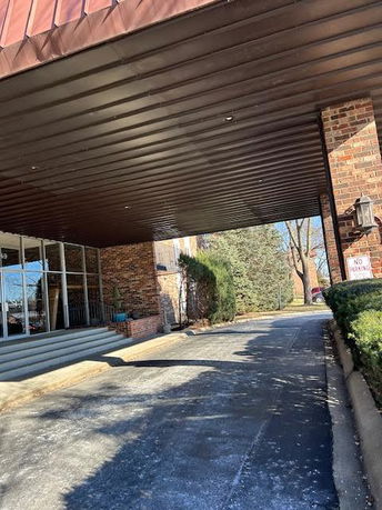 Front view of a building entrance with a covered driveway.