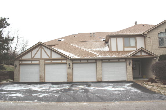 Front view of a multi-story house with multiple garages.