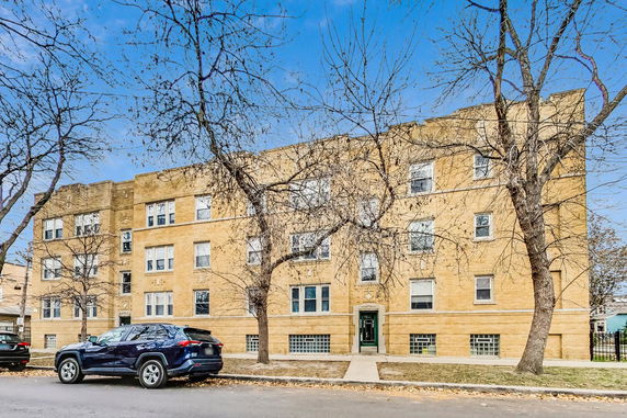 Front view of a multi-story brick apartment building.