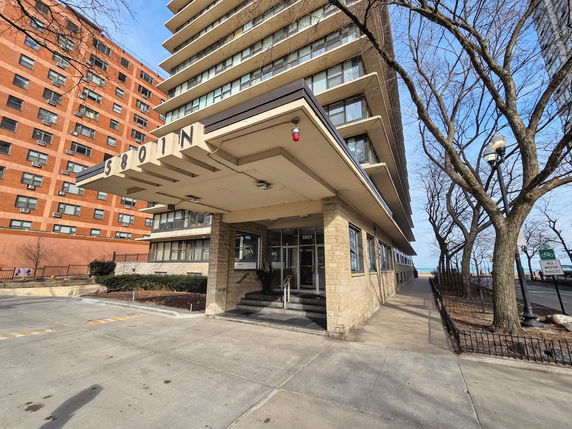 Front view of a multi-story building with a prominent entrance canopy.