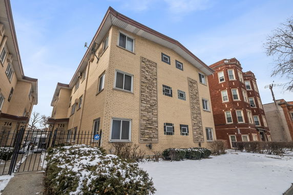 Front view of a multi-story brick apartment building.