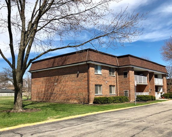 Front view of a two-story brick apartment building.