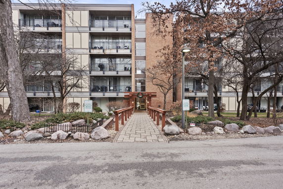 Front view of a multi-story residential building with balconies.