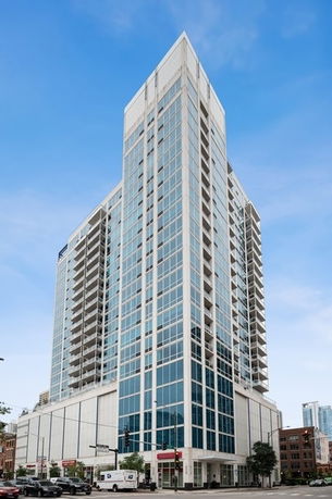 Front view of a high-rise building with glass windows.