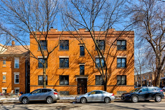 Front view of a three-story brick residential building