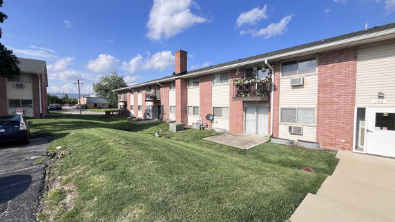 Front view of a two-story apartment building with brick and siding exterior.