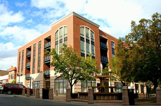 Front view of a multi-story brick building with large arched windows.
